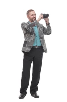 in full growth. smiling man with a camera. isolated on a white background.