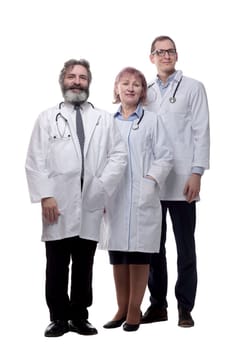 in full growth. a group of qualified doctors standing together . isolated on a white background