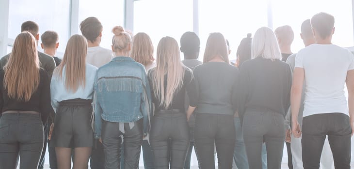 rear view. group of casual young people looking forward