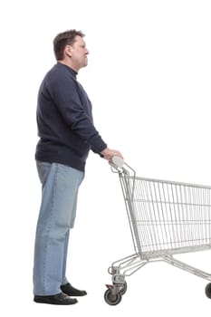 in full growth. casual mature man with shopping cart .isolated on a white background.