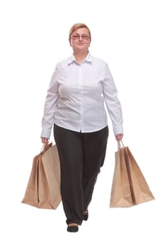 Full length portrait of a Senior woman walking with shopping bags and smilimg. Lucky shopping concept