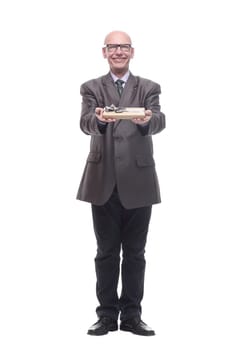 in full growth.business man with a gift box. isolated on a white background.