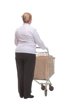 Rear view of casual woman with empty shopping cart on white background. Shopping concept