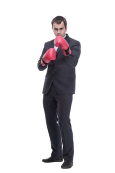 Full length portrait of a young businessman in suit with red boxing gloves posing isolated on white background
