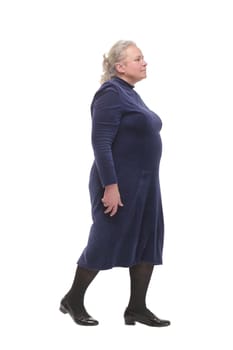 Side view full length profile shot of an elderly woman walking isolated on white background and looking forward