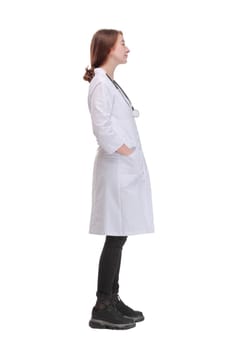 Beautiful young doctor woman wearing white coat over isolated background looking to camera with smile on face, natural expression.