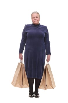 Mature woman holding bags smiling and looking at camera isolated over white background