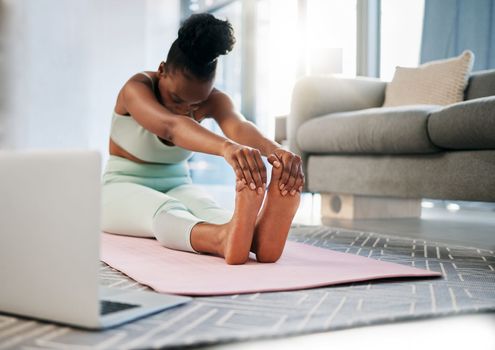 Yoga, stretching and black woman in online class for fitness, pilates training and home learning on laptop. Meditation, workout and person in living room with computer video or webinar for balance.