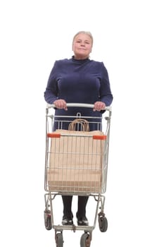 Full length shot of an elderly woman pushing a shopping cart isolated on white background smiling at camera