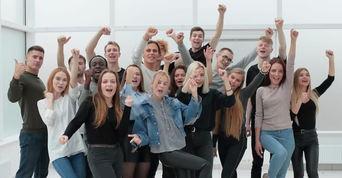 in full growth. a group of happy youths who are pointing ahead