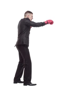 in full growth. young businessman in Boxing gloves. isolated on a white background.