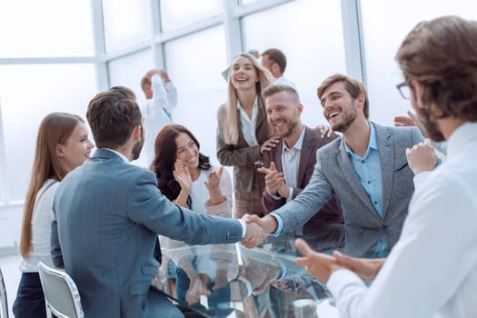 business people shaking hands sitting at the office Desk. concept of cooperation