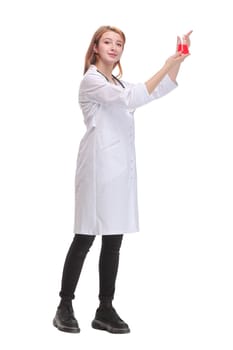 Smiling women doctor in medical suit holding beaker with red liquid. Concept of scientific research