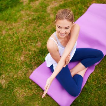 Its about being good to yourself. a young woman doing yoga outdoors