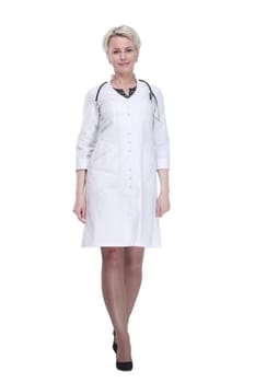 in full growth. confident female doctor stepping forward . isolated on a white background.