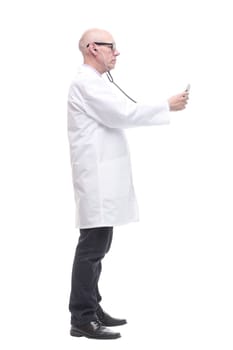 in full growth. confident doctor with a stethoscope in hand. isolated on a white background.