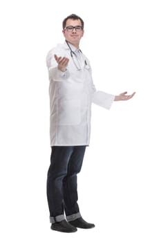 Side view full length confident male medical doctor in uniform looking at camera, standing on white background