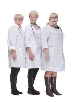 in full growth. group of qualified doctors standing together. isolated on a white background.