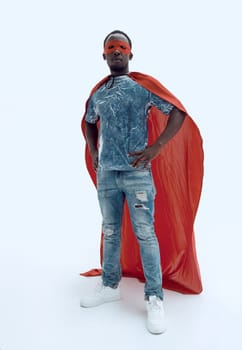 in full growth. confident guy in jeans and a superhero raincoat. photo with copy space