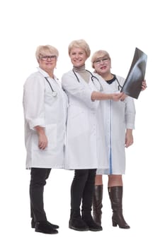 in full growth. group of qualified doctors discussing an x-ray. isolated on a white background.