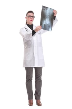Front view of female doctor wearing stethoscope and glasses looking at an x-ray. Concept of medical help