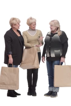 in full growth. three happy women with shopping bags. isolated on a white background.