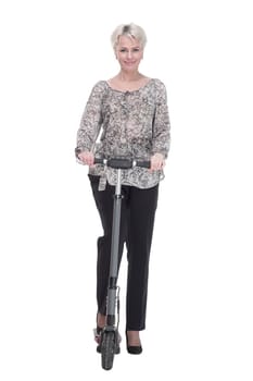 in full growth. elegant young woman with an electric scooter . isolated on a white background.