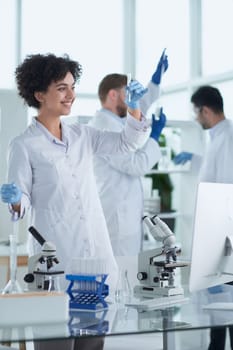 Team of Scientists Working Using Microscope, Analysing Microbiology Samples