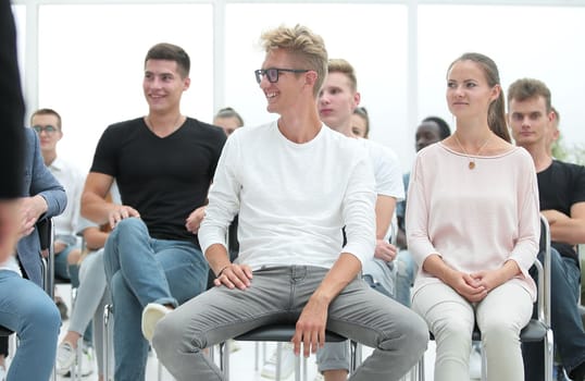 close up. a group of young people sitting in a conference room. business and education