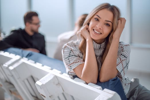 young business woman sitting in office lobby at coffee break. office weekdays