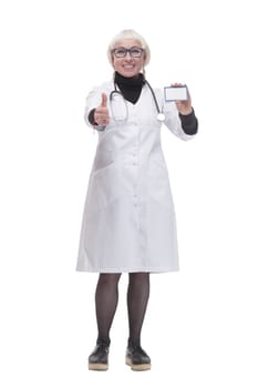 in full growth. medical doctor woman showing her visiting card. isolated on a white background.