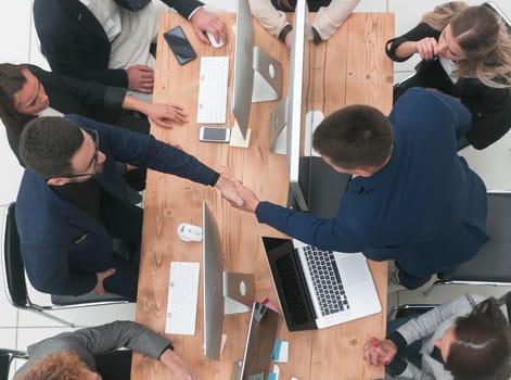 top view. business colleagues supporting each other with a handshake.