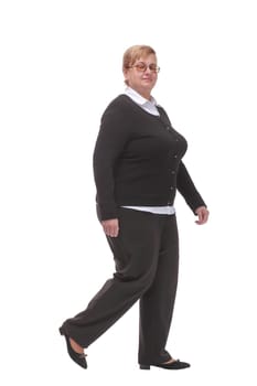 Side view full length profile shot of an elderly woman walking isolated on white background and smiling