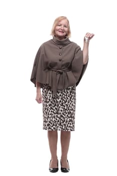 in full growth. happy mature woman with keys in hand. isolated on a white background.