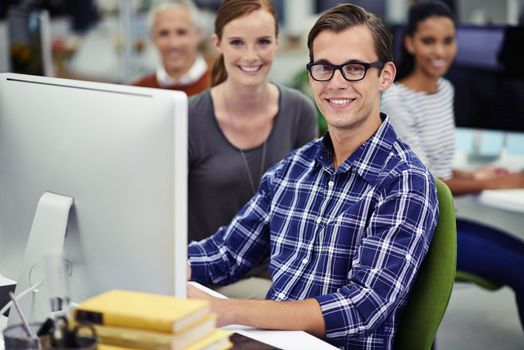 Weve got everything covered. coworkers sitting at computers in an office