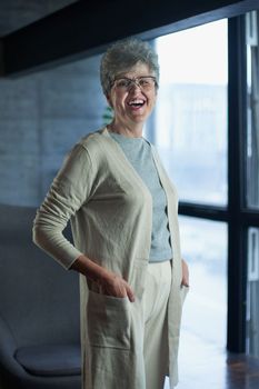 Close up portrait of beautiful senior woman posing at home