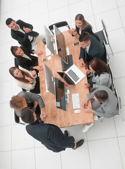 top view. business colleagues shaking hands at an office meeting. business concept