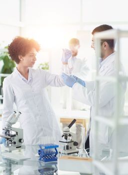 Team of Scientists Working Using Microscope, Analysing Microbiology Samples