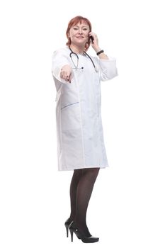 in full growth. medical woman with a smartphone. isolated on a white background.