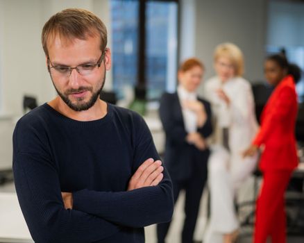 A middle-aged man is upset because of the ridicule of his female colleagues. Discrimination against men in the office