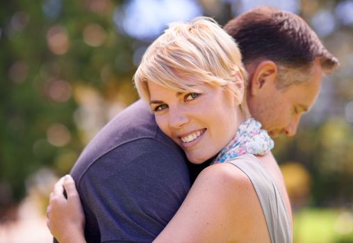 I love him more everyday. a mature couple embracing outdoors