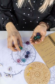 Woman numerologist astrologer counts numbers. Selective focus. People.