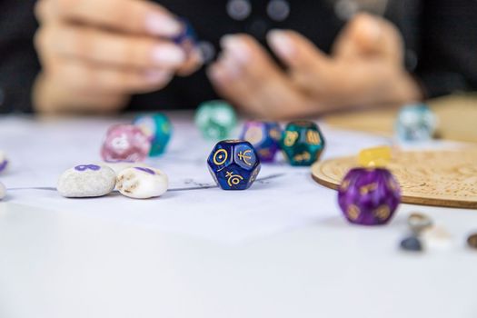 Woman numerologist astrologer counts numbers. Selective focus. People.