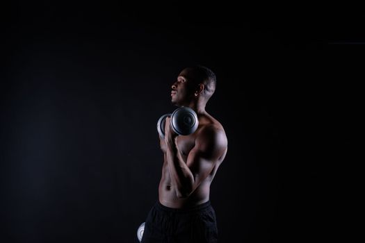 Portrait of happy african man with dumbbells over red background