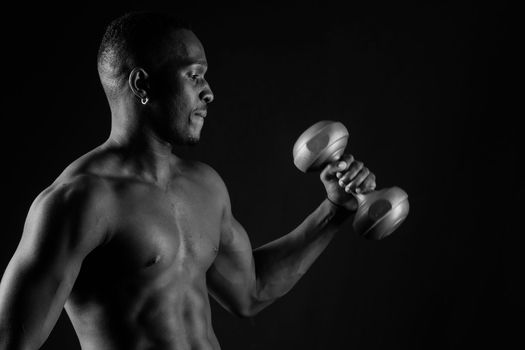 Portrait of happy african man with dumbbells over red background