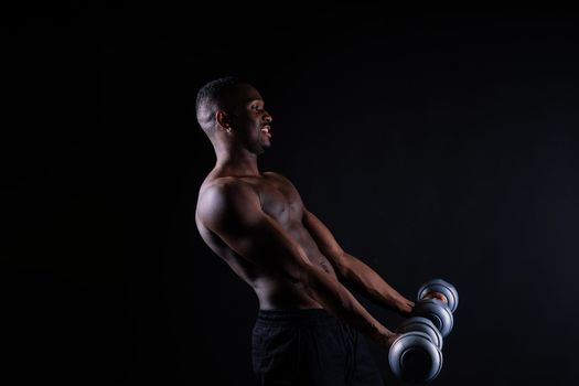 Portrait of happy african man with dumbbells over red background