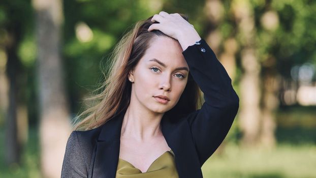Portrait of a young student in a city park