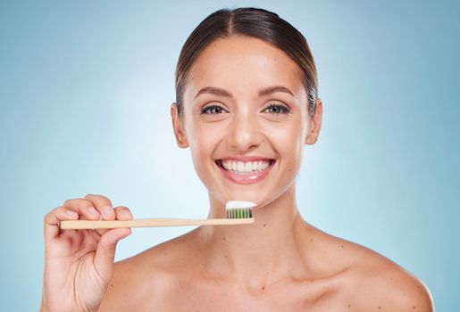 Brushing teeth, dental and woman with toothbrush for teeth whitening and beauty, oral health and fresh breath with studio background. Mouth wellness, Invisalign portrait and clean with bamboo brush