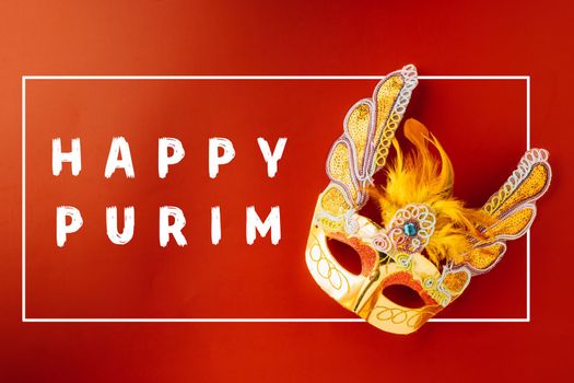 Happy Purim carnival. Carnival mask for Mardi Gras celebration isolated on red background with copy space, jewish holiday, Purim in Hebrew holiday carnival ball, Venetian mask, masquerade accessory