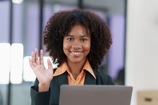 Beautiful American women smiling and using video call application on laptop.